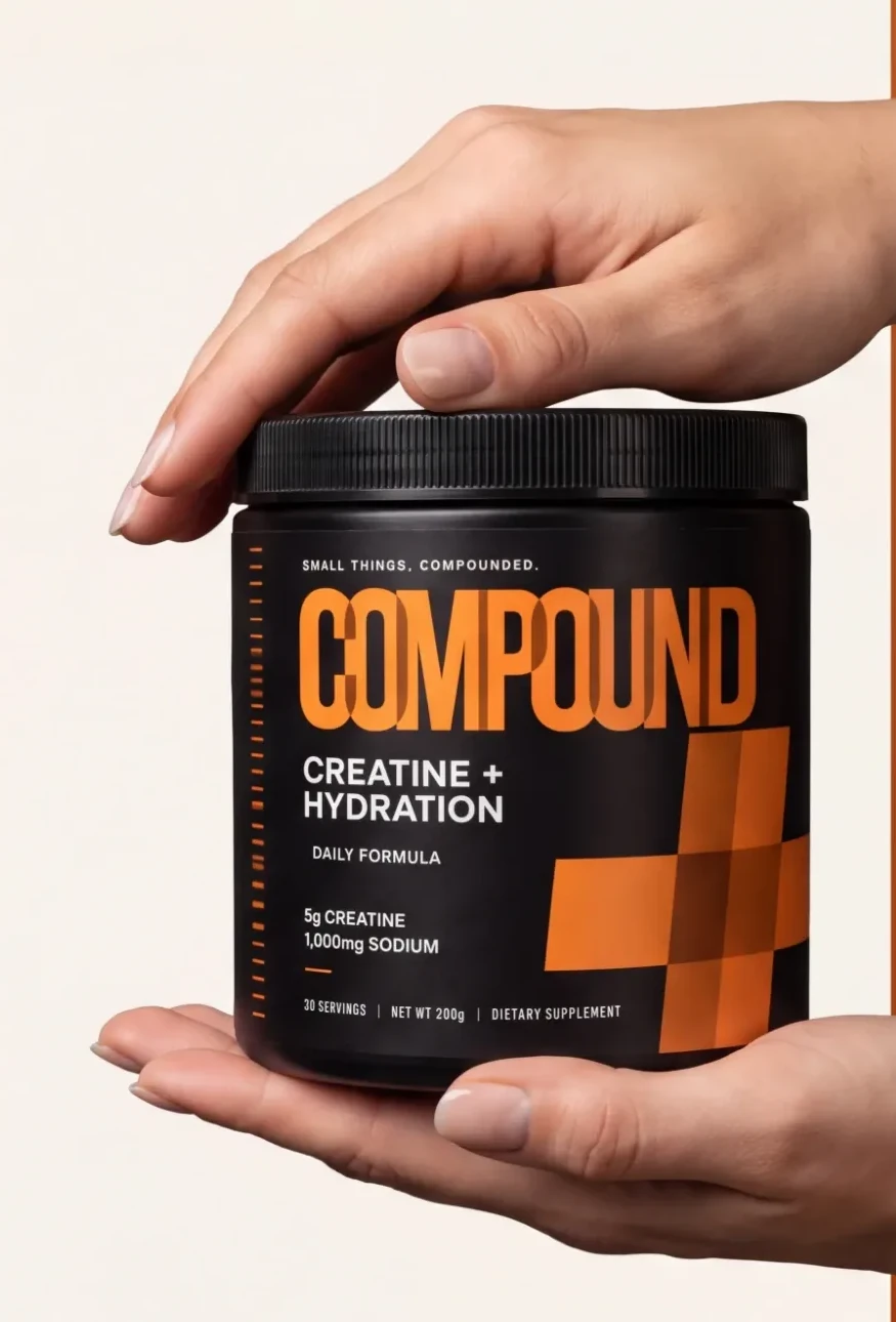 Hands holding a tub of Compound Creatine + Hydration
